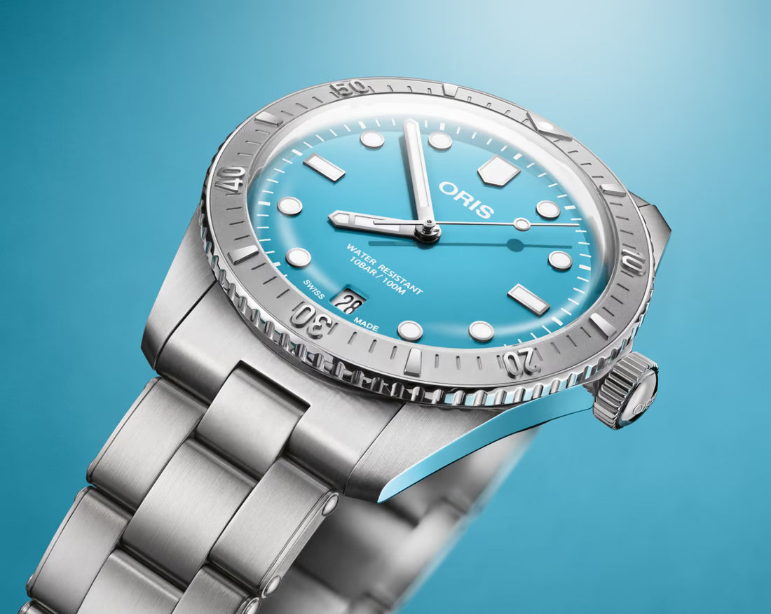 Oris Divers Sixty-Five Cotton Candy Unisex 01 733 7771 4055-07 8 19 18 horloge 38mm met turquoise wijzerplaat en roestvrijstalen band. Luxe Swiss Made heren horloge geschikt voor dames en heren.