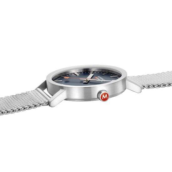 Mondaine Classic Spoorweg Horloge 40mm M660.30360.40SBJ met blauwe wijzerplaat, roestvrijstalen mesh band en Zwitsers quartz uurwerk voor heren.
