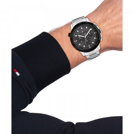 Tommy Hilfiger TH1792106 Troy Herenhorloge 46mm met zilverkleurige schakelband en zwarte wijzerplaat, gedragen om pols van man. Stijlvol accessoire voor modebewuste heren.